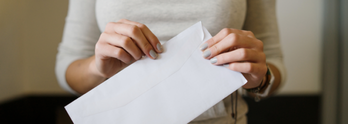 women holding a white envelope